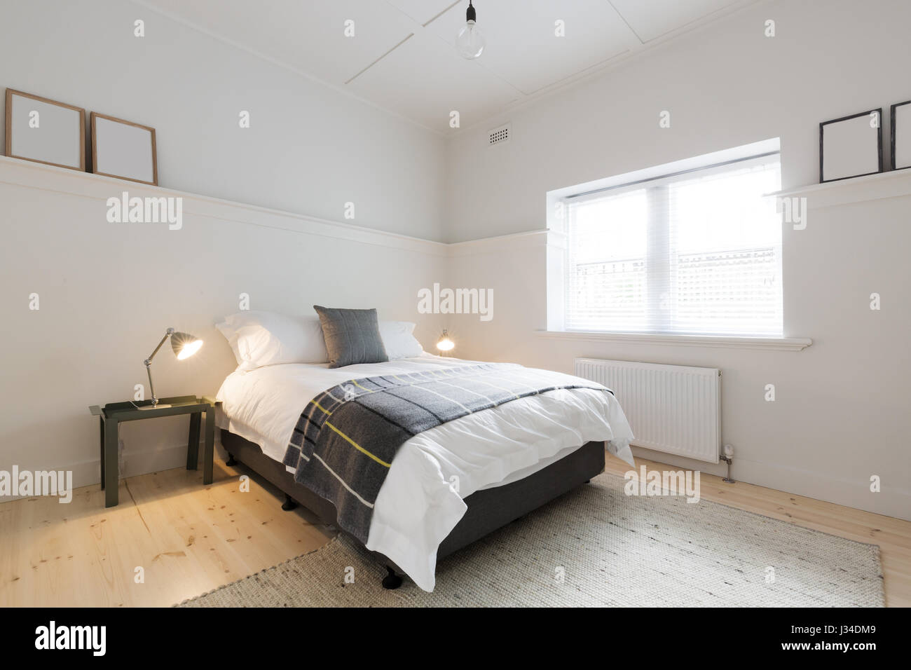 Danish contemporary styled guest bedroom in luxury renovated modern Ausrtralian apartment Stock Photo