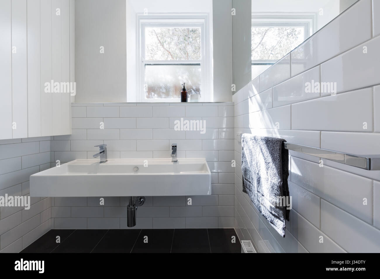 Double basin vanity in modern white renovated bathroom in heritage building horizontal Stock Photo