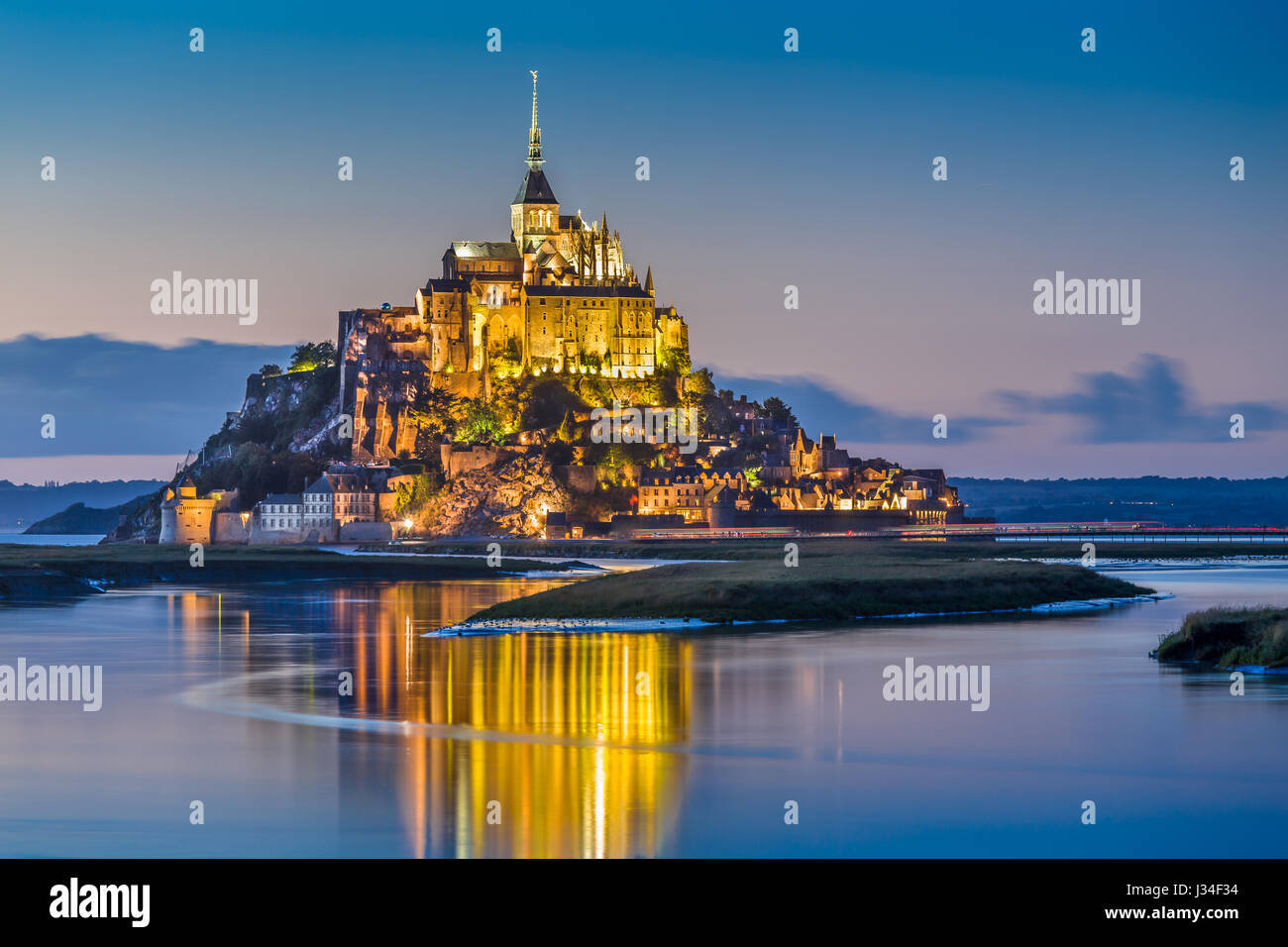 Beautiful view of famous Le Mont Saint-Michel tidal island in beautiful twilight during blue hour at dusk, Normandy, northern France Stock Photo