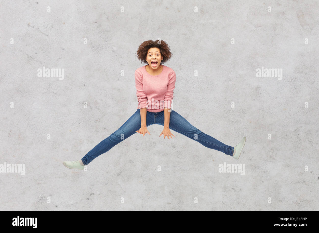 happy african american woman jumping over white Stock Photo - Alamy
