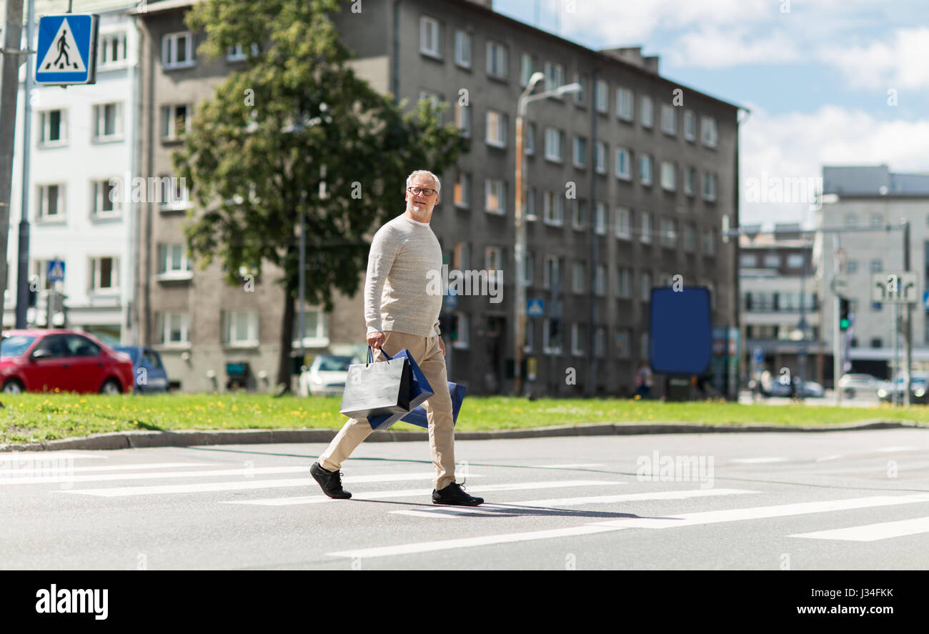 Walking shopping man bags hi-res stock photography and images - Alamy