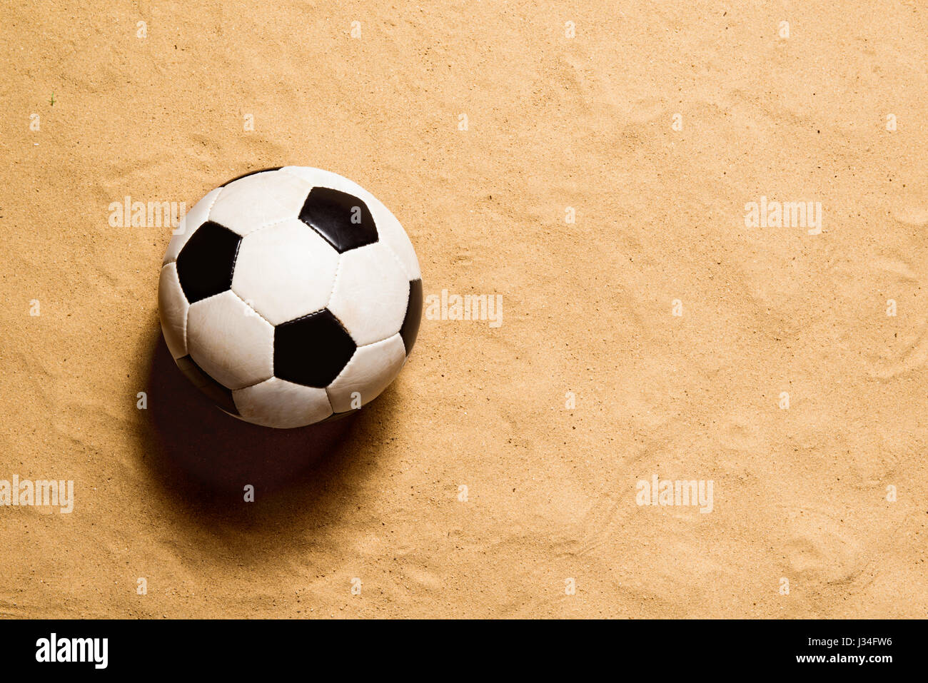 Soccer ball against sandy beach. Studio shot. Copy space. Stock Photo