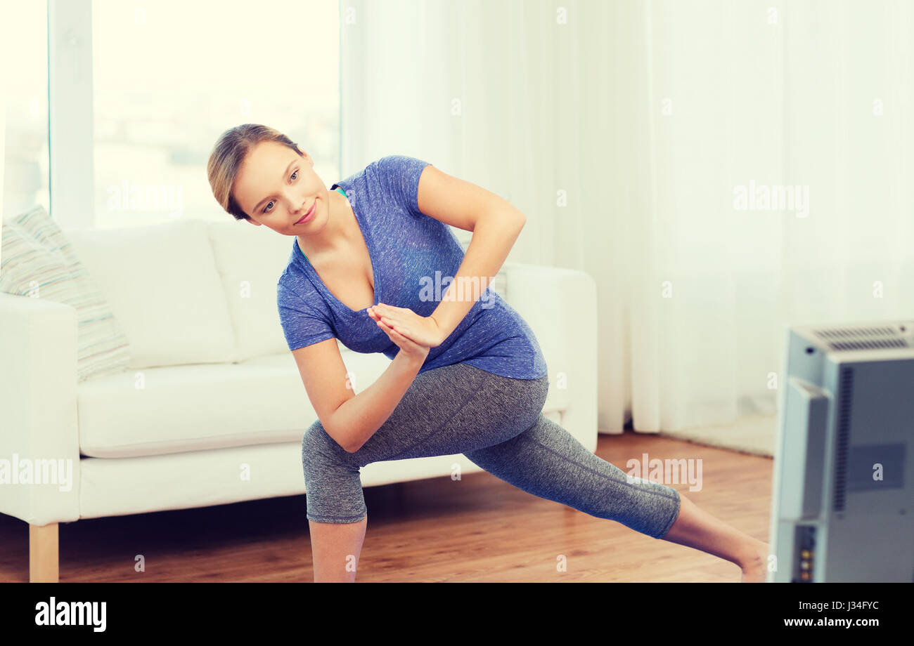 woman making yoga low angle lunge pose on mat Stock Photo - Alamy