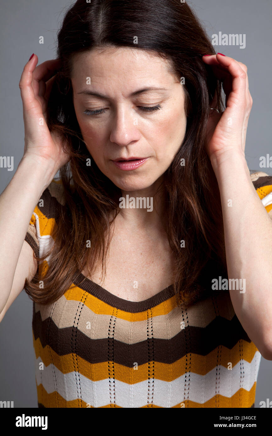 Woman in retro Dress Holding Back hair Stock Photo