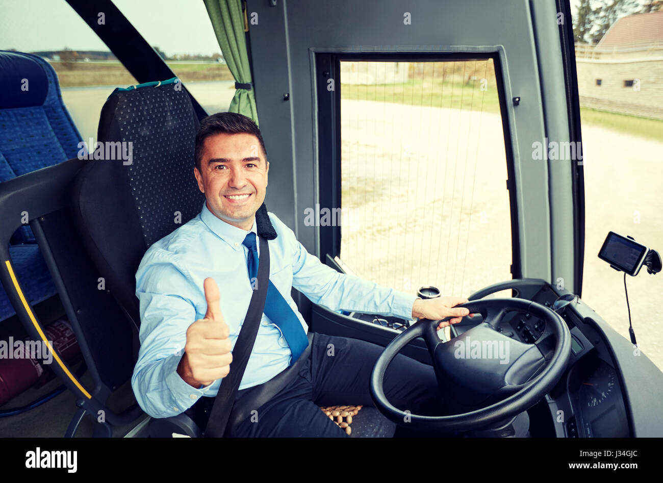 Smiling bus driver showing thumbs hi-res stock photography and images ...