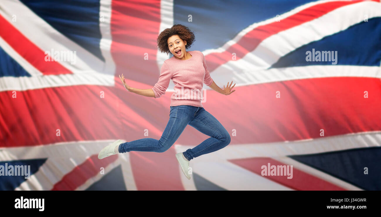 african american woman jumping over english flag Stock Photo - Alamy