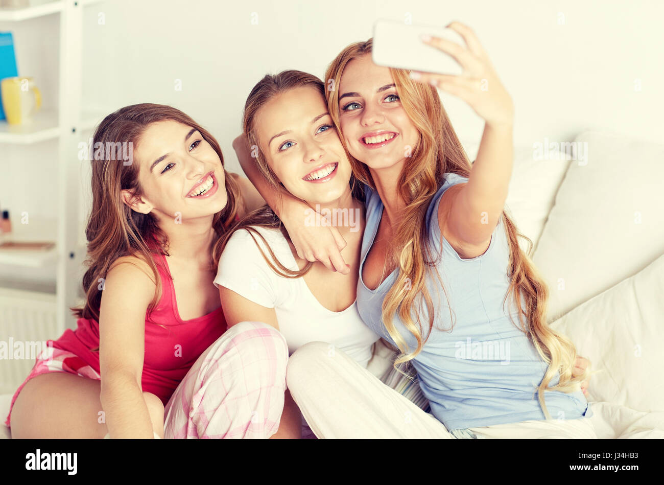 teen girls with smartphone taking selfie at home Stock Photo