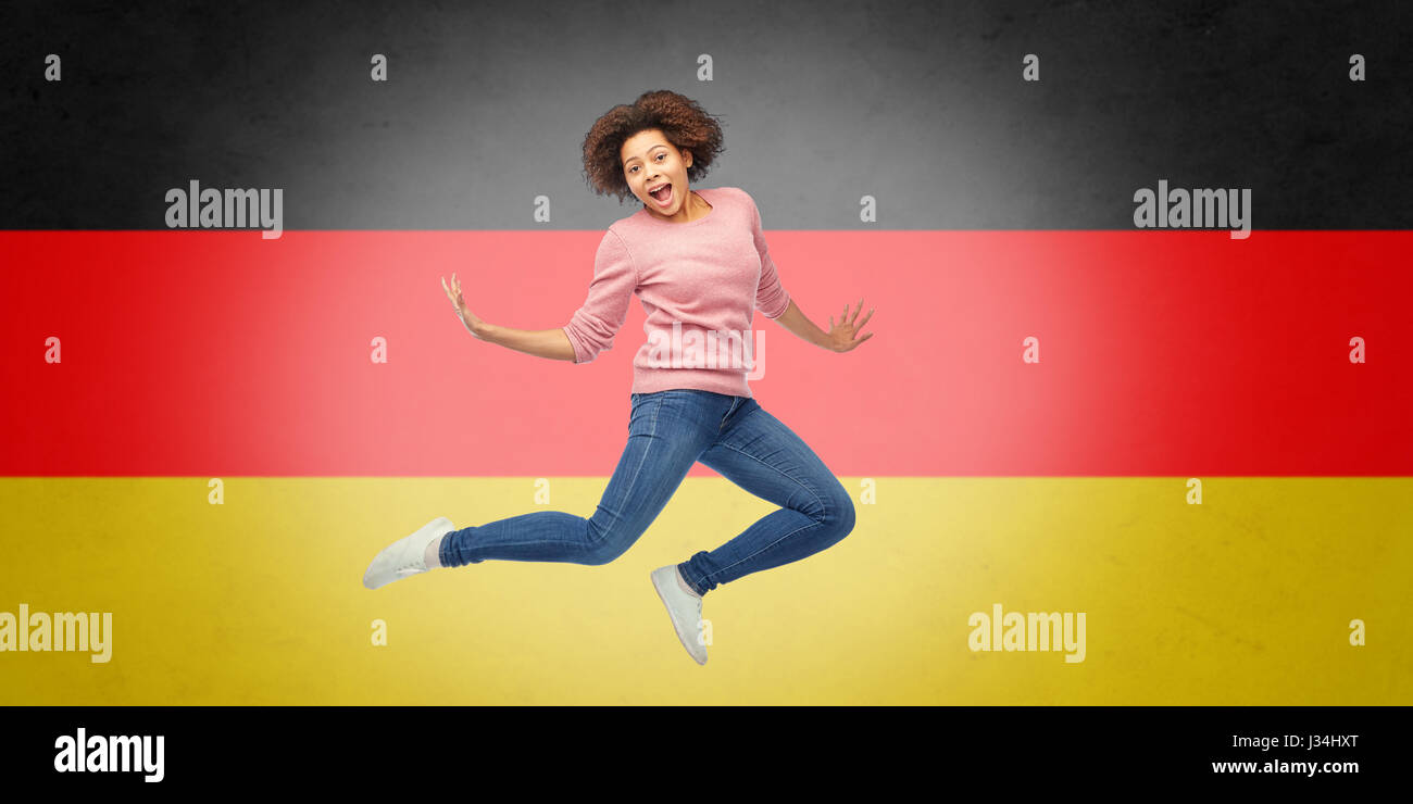african american woman jumping over german flag Stock Photo - Alamy