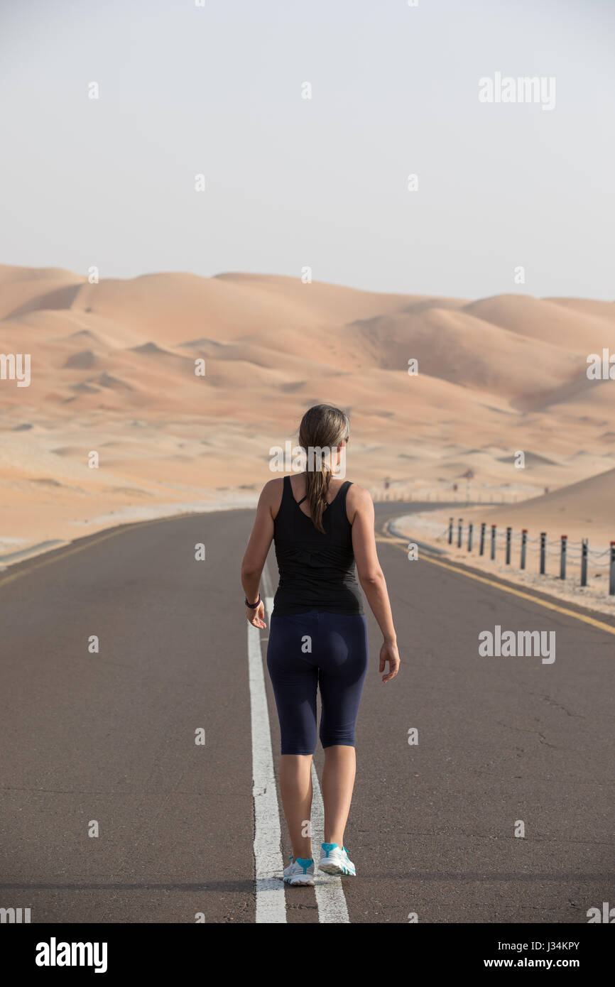 Woman running in liwa desert hi-res stock photography and images - Alamy