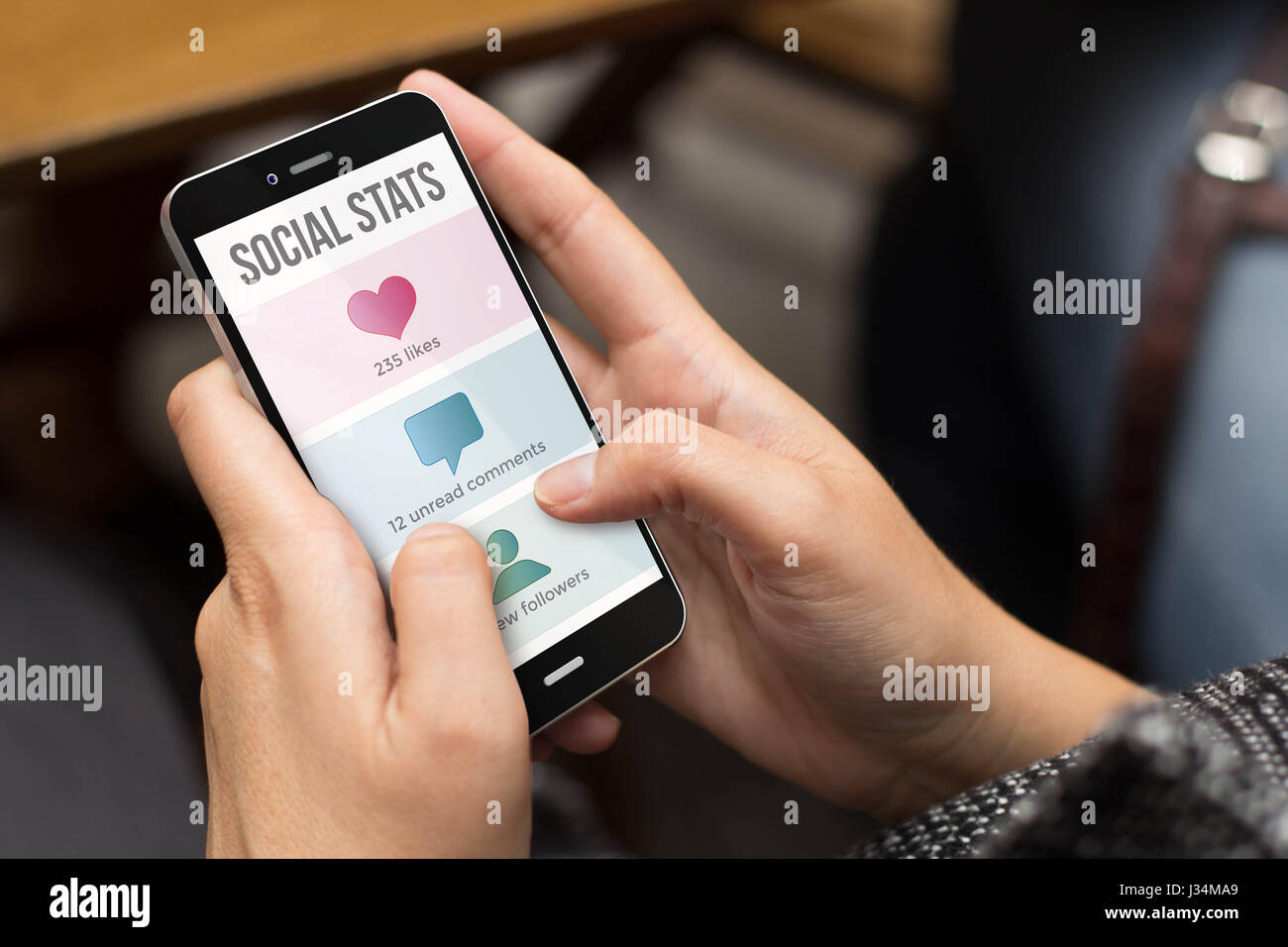 mobile design concept: girl using a digital generated phone with social stats on the screen. All screen graphics are made up. Stock Photo
