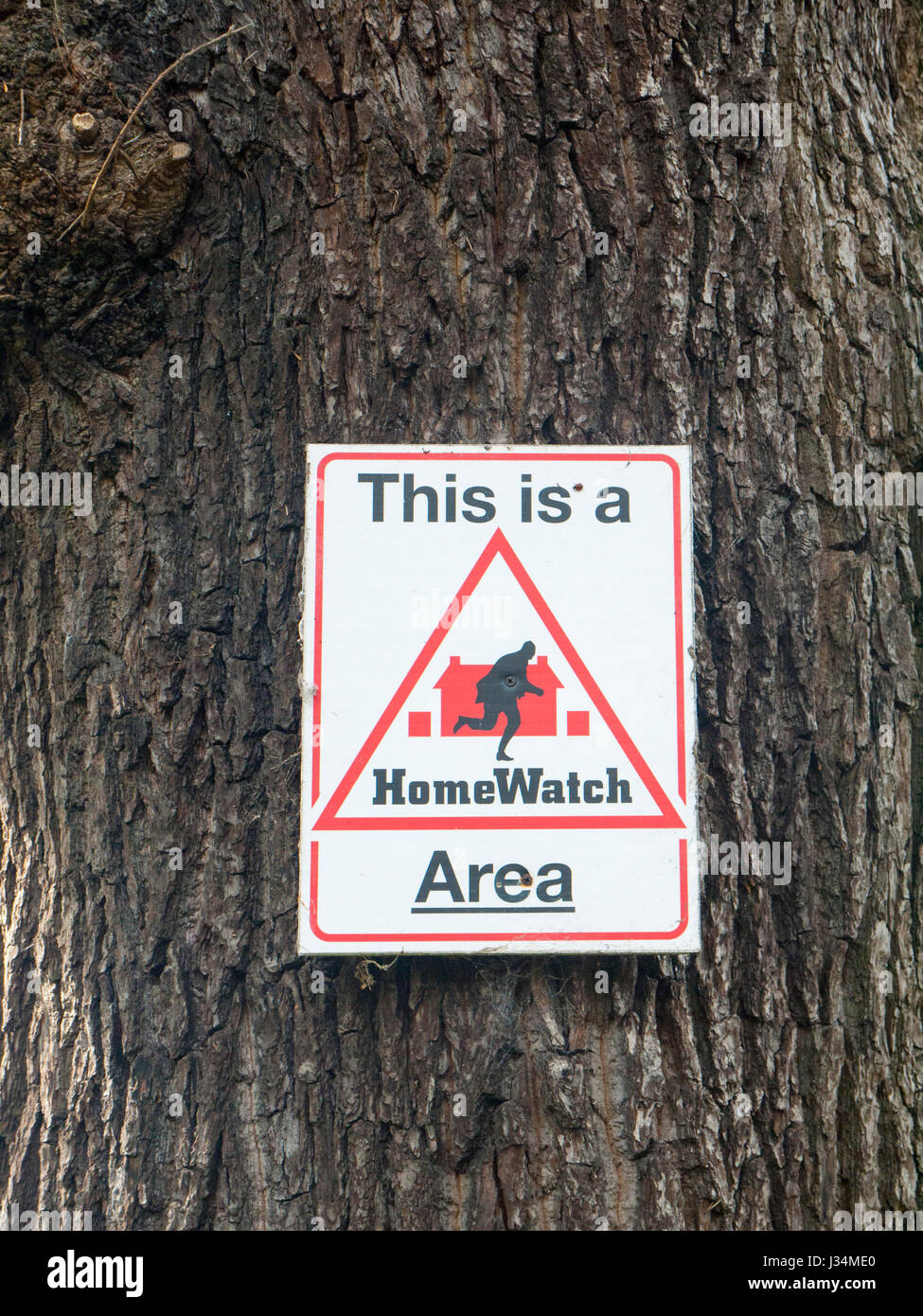 This is a homewatch area sign on tree UK Stock Photo Alamy