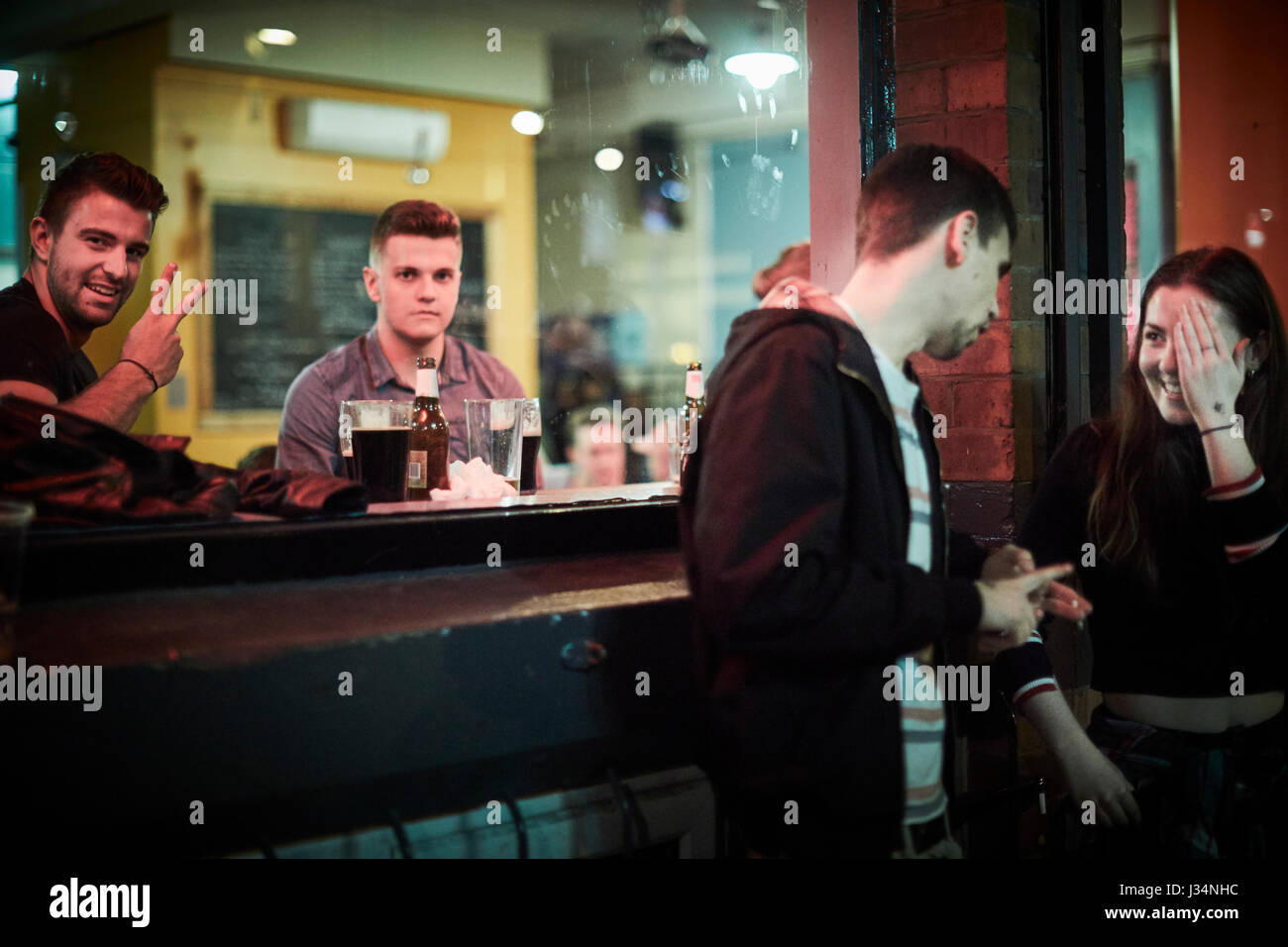 Manchester city centre , late night couple talking in the Northern Quarter. Stock Photo