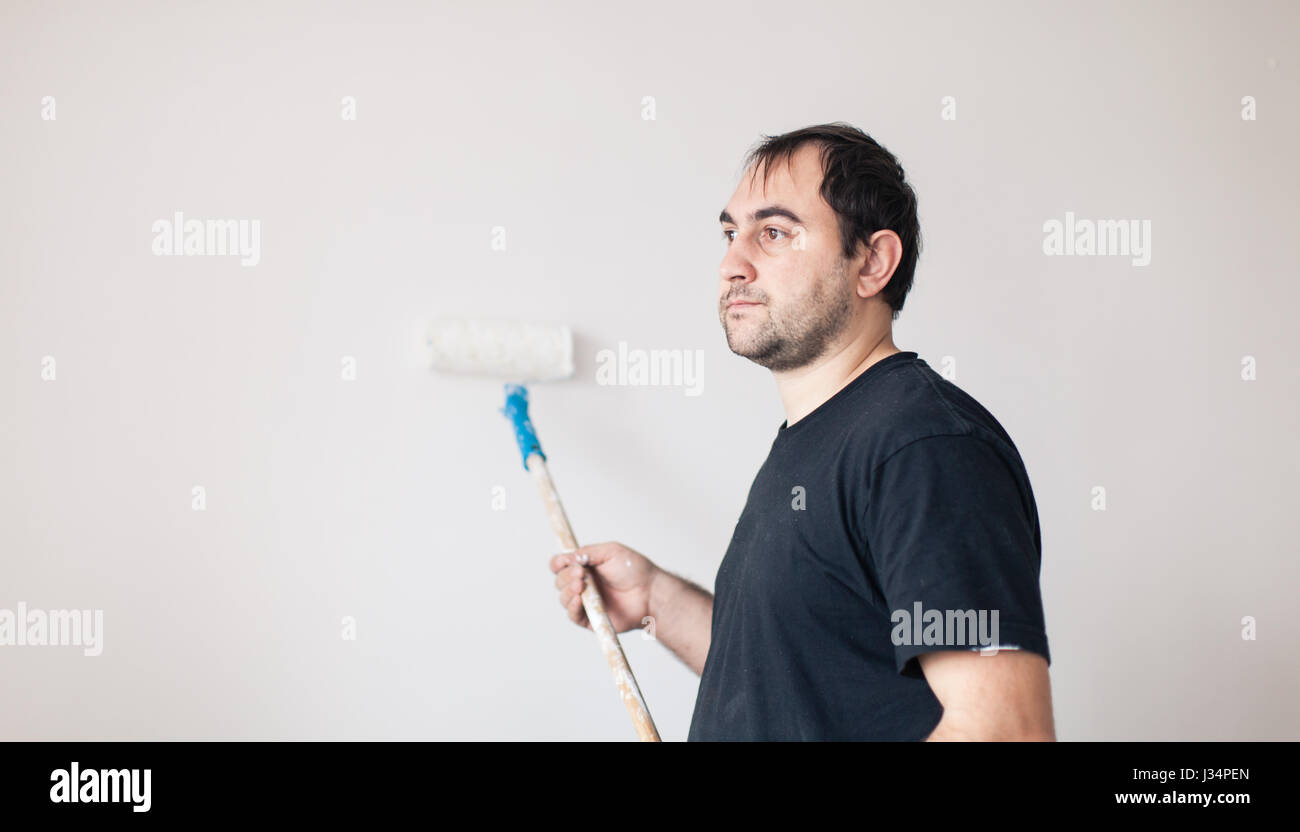 Man paints a wall in white Stock Photo Alamy