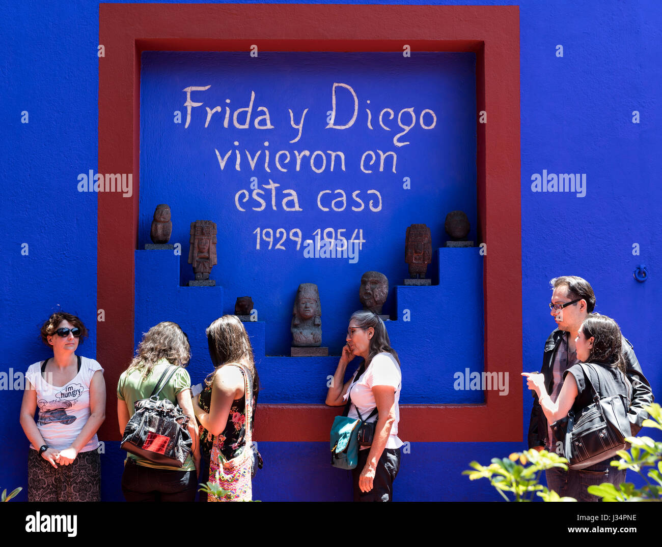 Mexico City, Mexico - 22 April 2017: Tourists on line awaiting admittance to the Frida Kahlo Museum. Sign reads 'Frida & Diego lived in this house.' Stock Photo