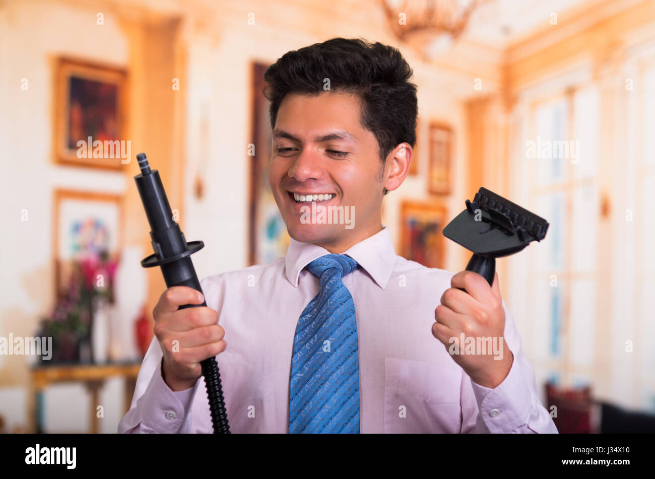 Handsome young Man at home fixing a vacuum cleaner Stock Photo - Alamy