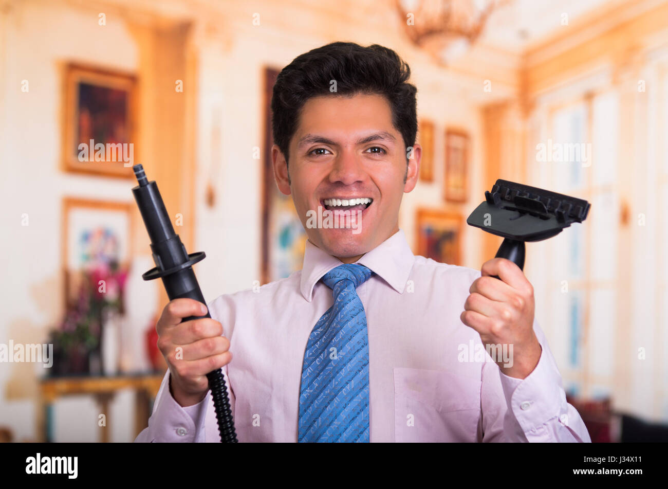 Handsome young Man at home fixing a vacuum cleaner Stock Photo - Alamy