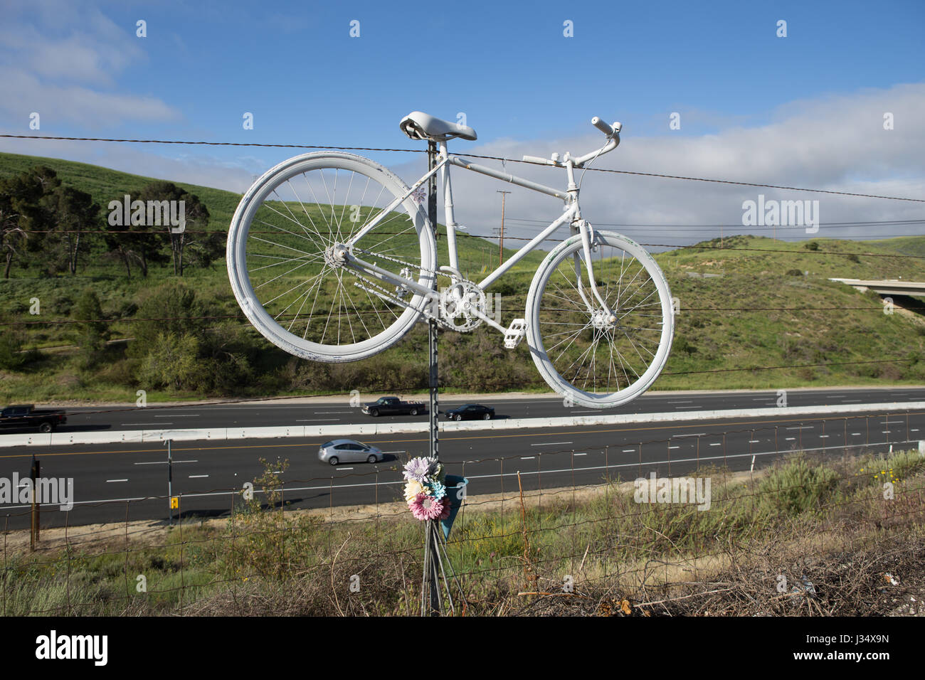 White ghost bike roadside memorial for killed cyclist  on Santiago Canyon Road in Orange County, California Stock Photo