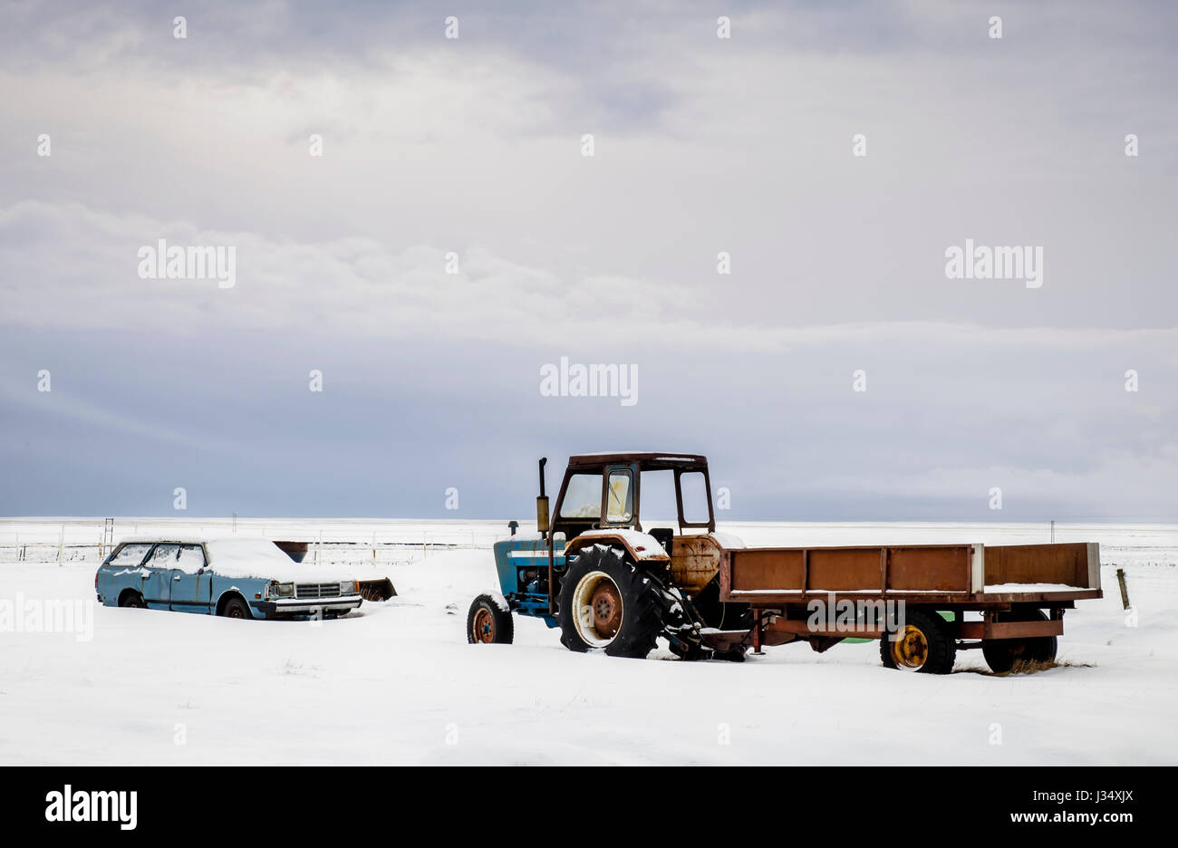 ICELAND - CIRCA MARCH 2015: Old cars covered in snow close to a farrm in South Iceland during winter time. Stock Photo