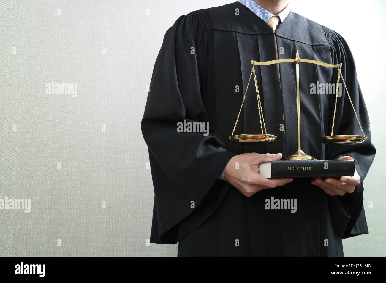 justice and law concept.Male judge in a courtroom with the balance scale and holy book Stock Photo
