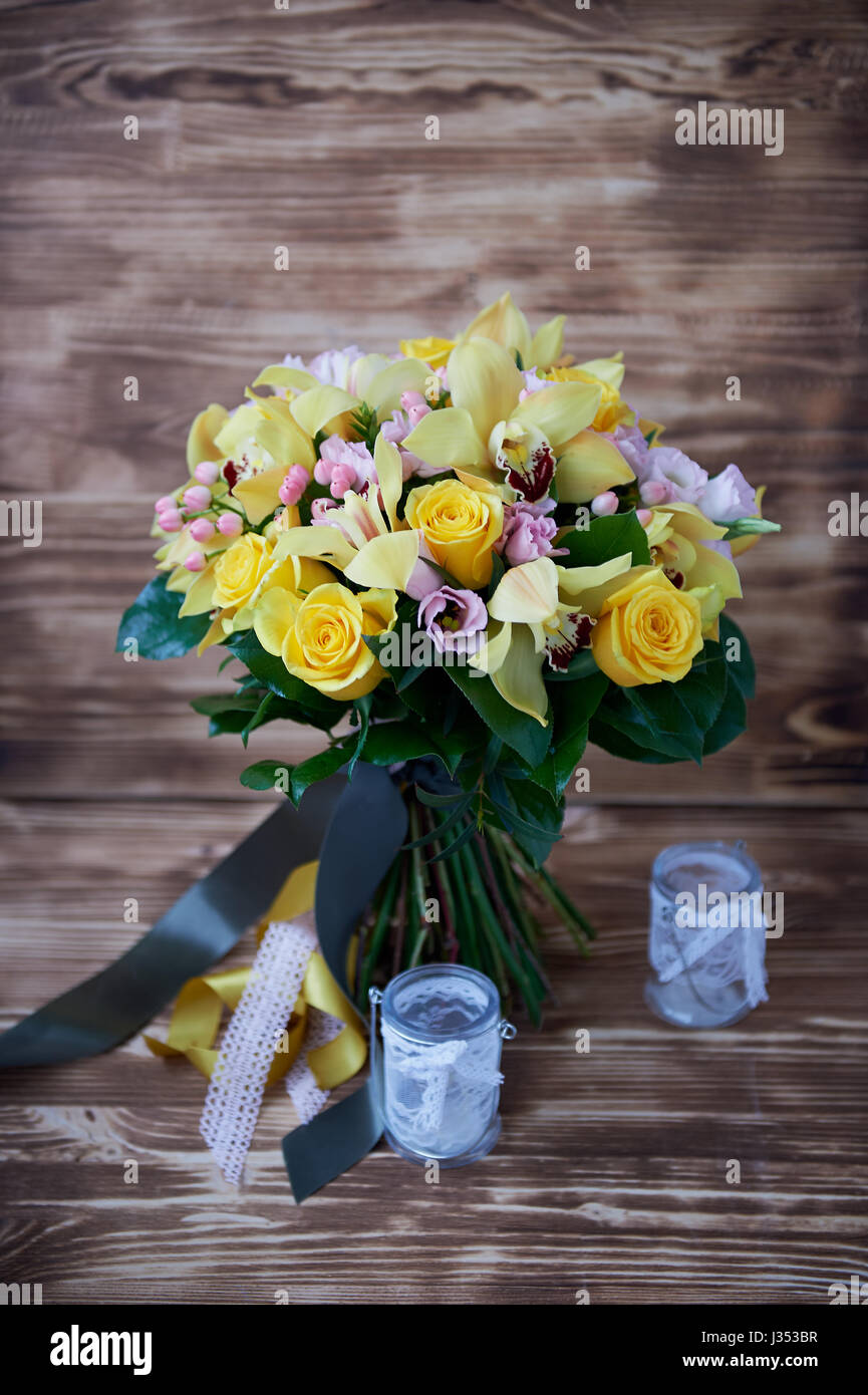 Fresh yellow bouquet of yellow roses and pink berries.Bright colors Stock Photo