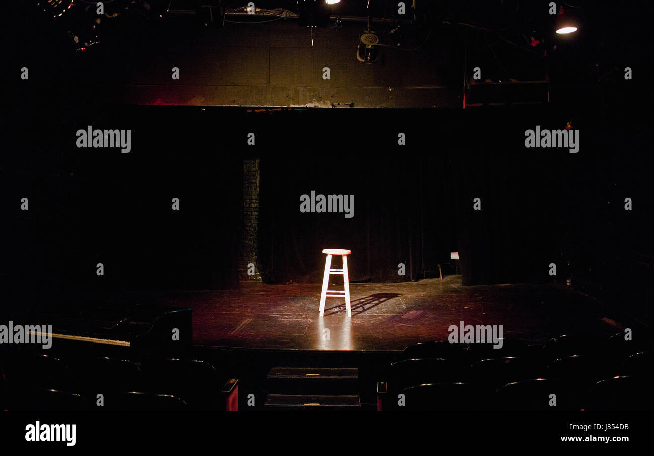 An empty stool spot lit on a stage Stock Photo - Alamy