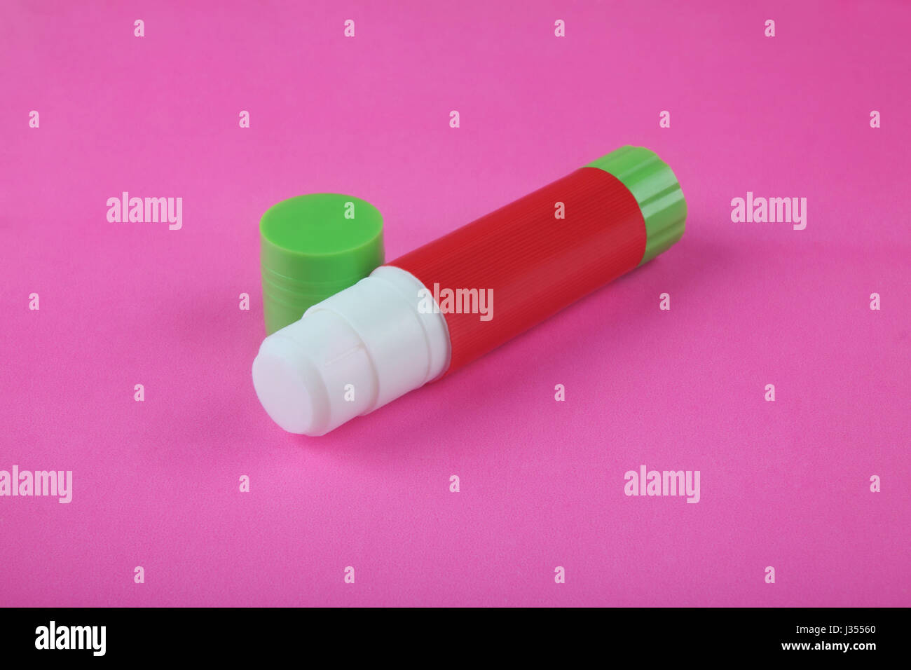 Glue Stick on Pink Background Stock Photo