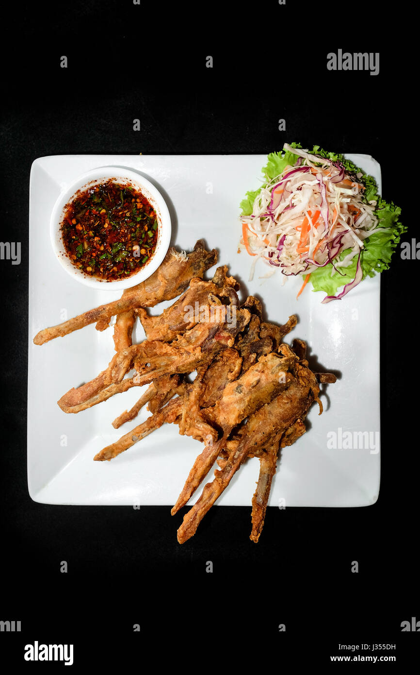 Fried duck mouth, Dish of deep fried seasoning duck mouth on black