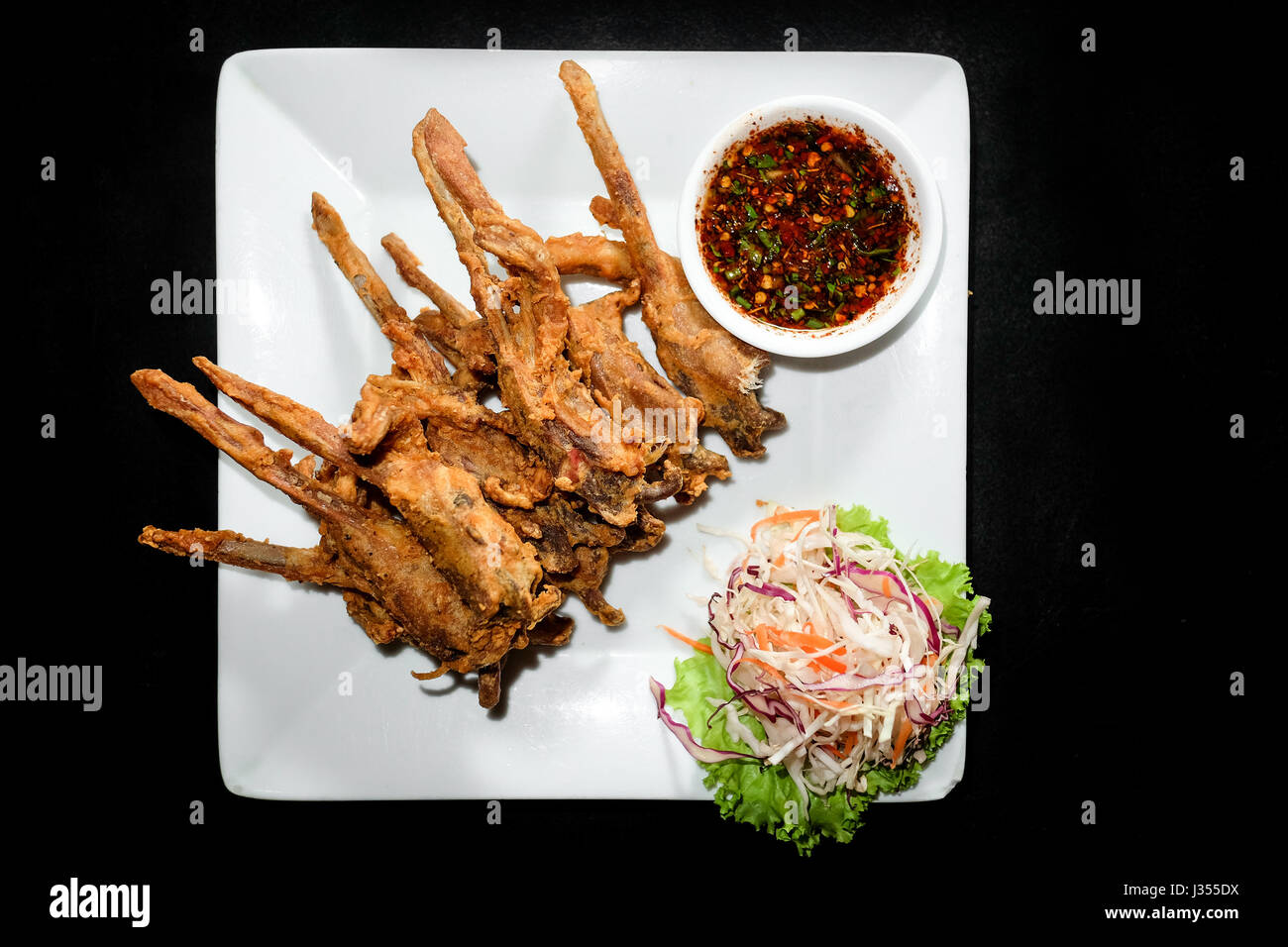 Fried duck mouth, Dish of deep fried seasoning duck mouth on black