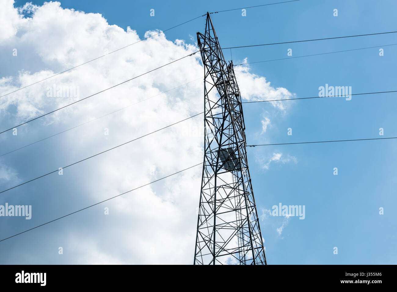 Power line tower against blue sky. Stock Photo