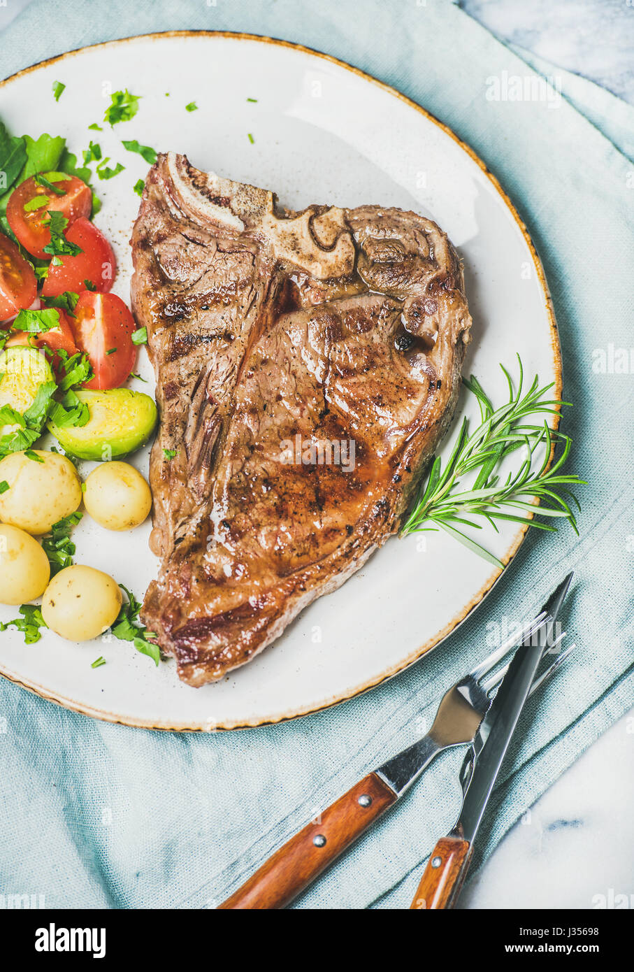 Meat dinner plate with cooked beef tbone steak Stock Photo