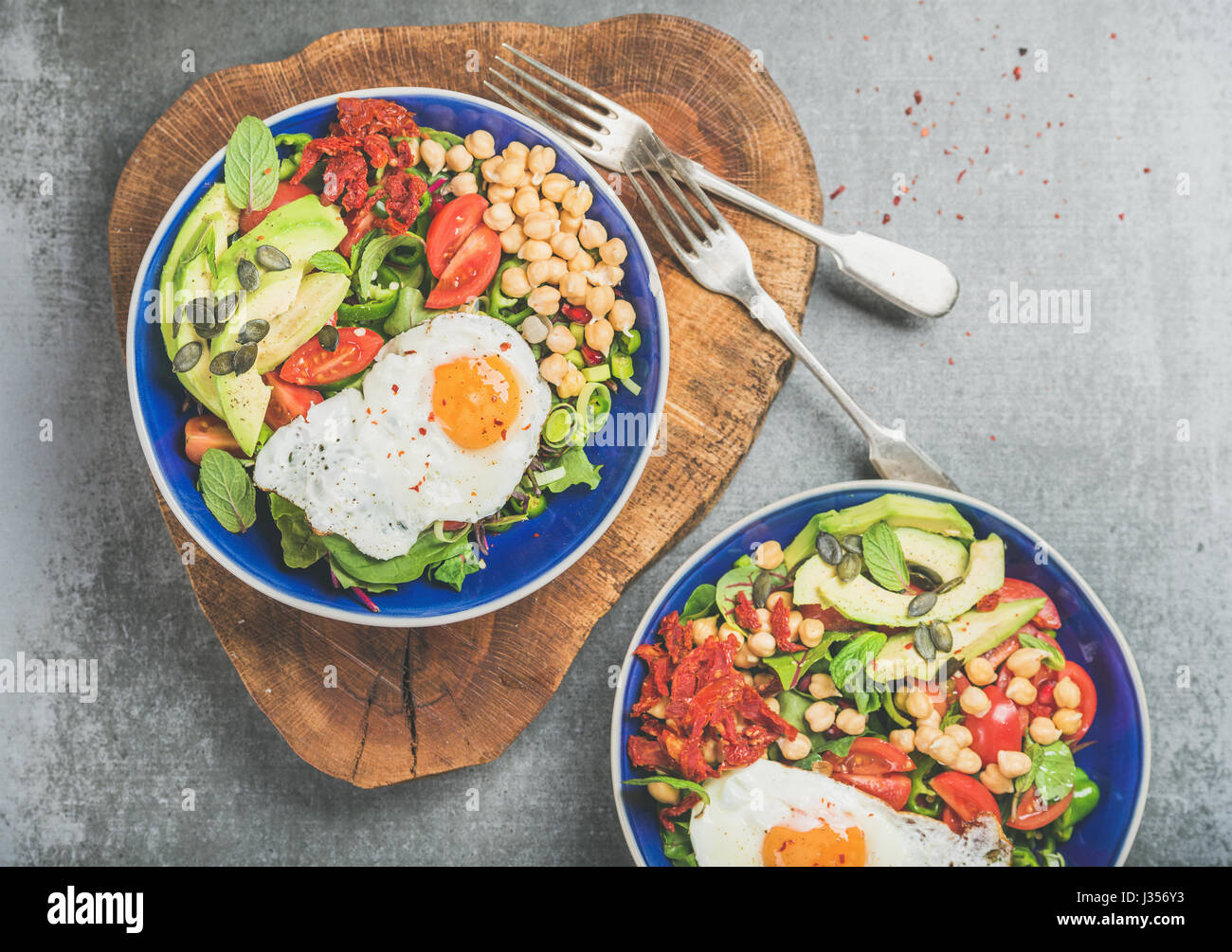 Healthy breakfast bowls with fried egg, chickpea sprouts, seeds