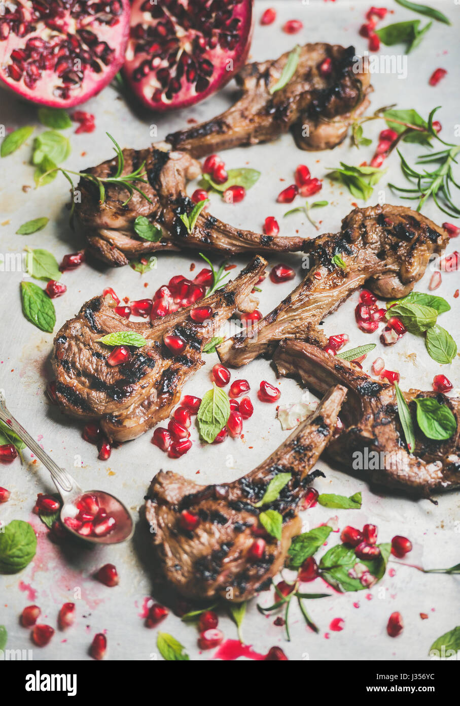Grilled lamb ribs with pomegranate seeds, fresh mint and rosemary Stock
