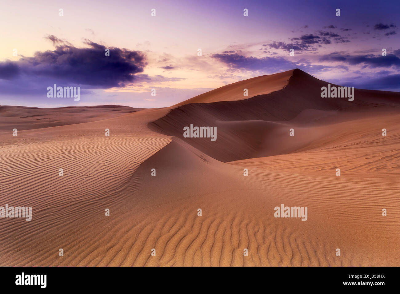 Lifeless sand desert with chain of dunes at sunrise. Stockton beach sand dunes in NSW, Australia. Stock Photo