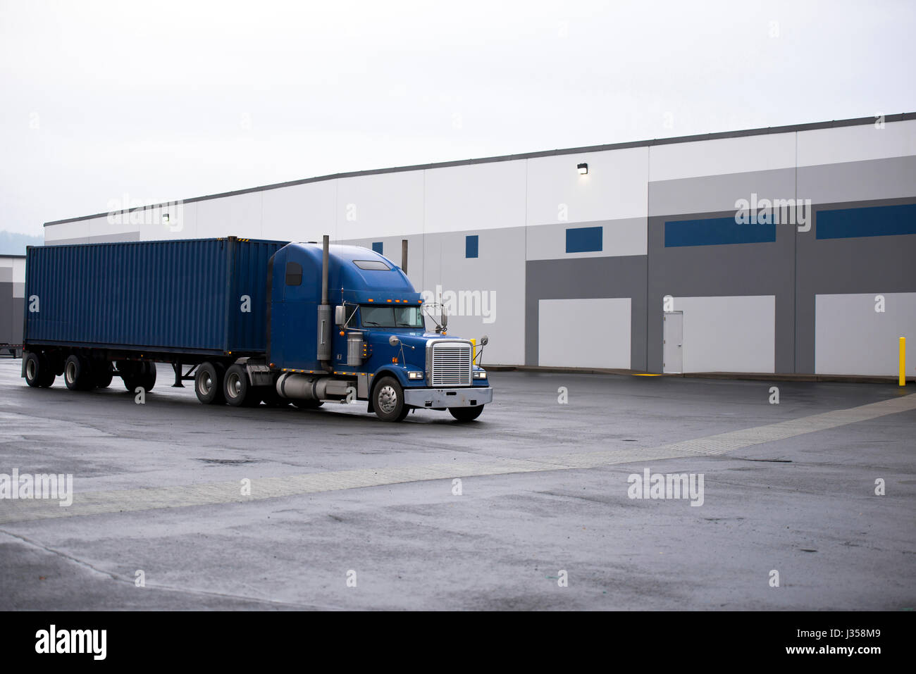 Blue classic bold powerful big rig semi truck with a container on a ...