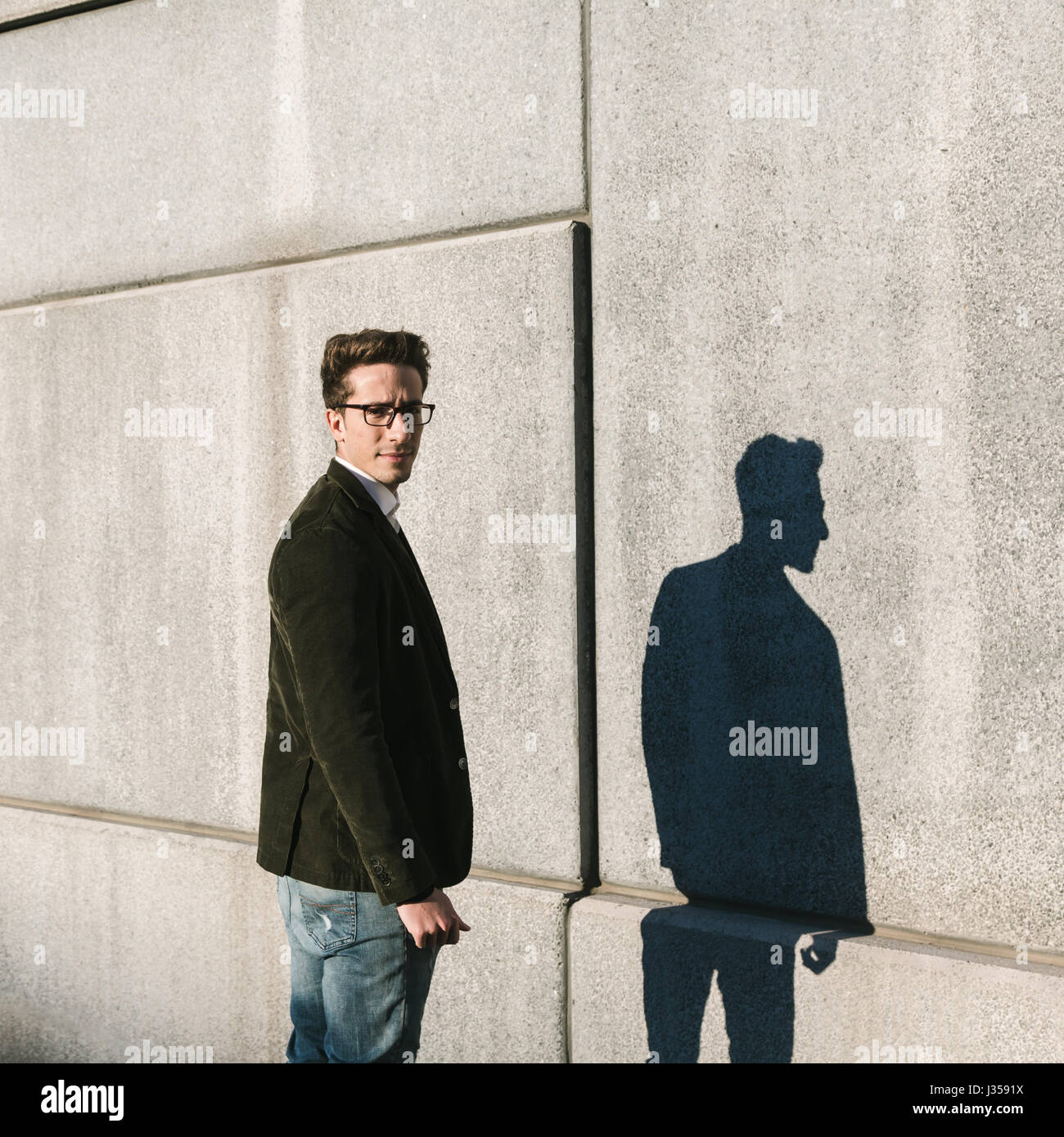 Young handsome man with short hair posing in front of his shadow Stock  Photo - Alamy