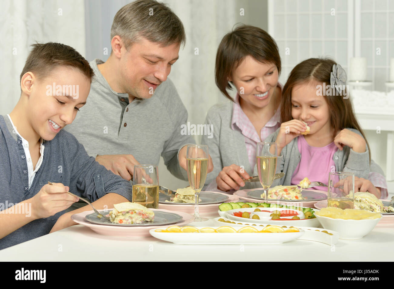 Happy parents with their children eating  Stock Photo