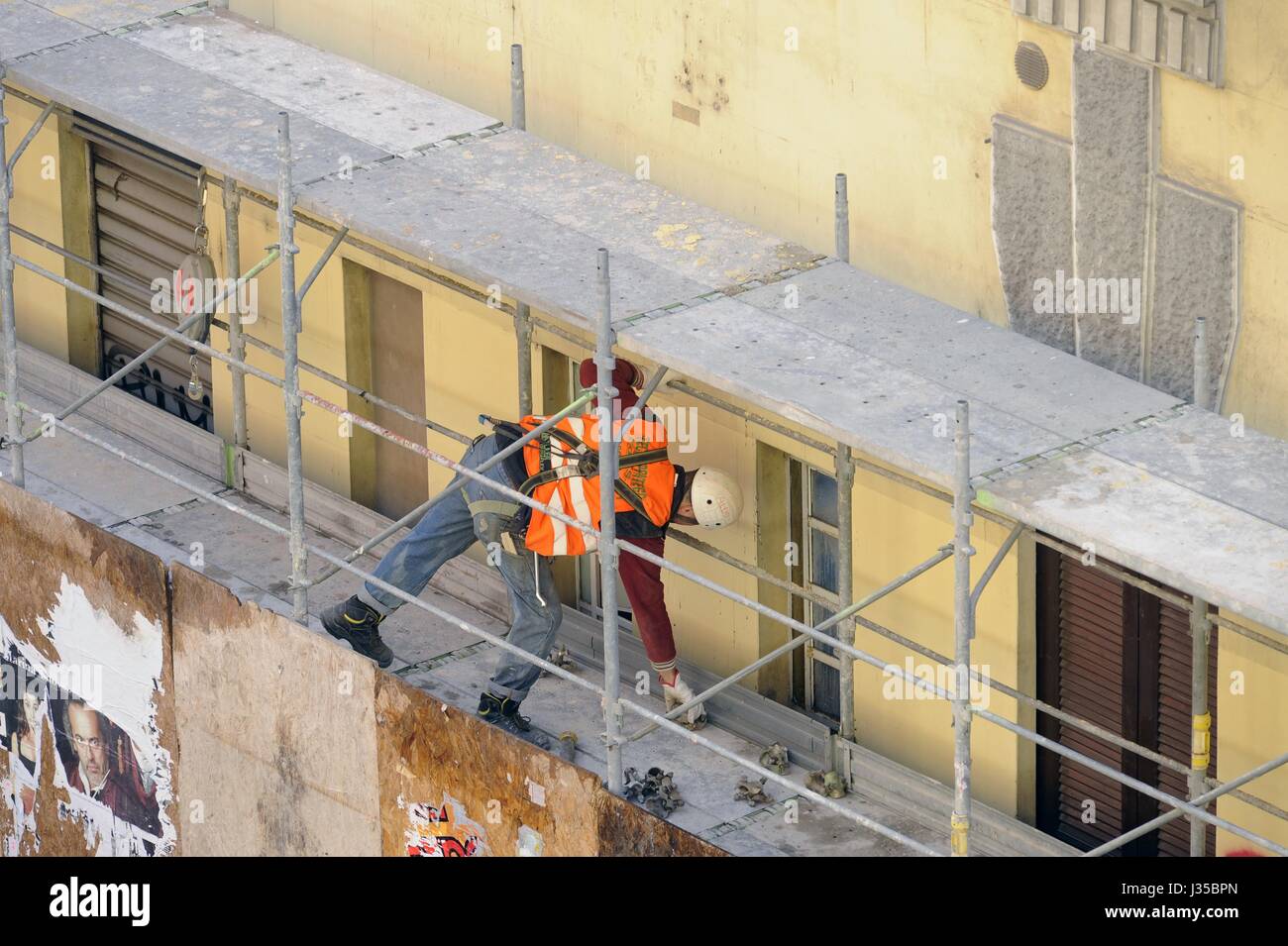 Construction workers on the scaffolding for the renovation of a building Stock Photo