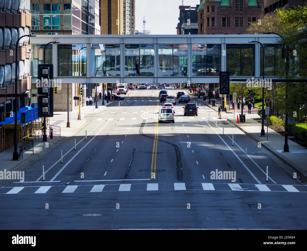 May 3, 2017 - Minneapolis, Minnesota, U.S - A pedestrian skyway crossing 3rd Ave in Minneapolis. The skyways are enclosed pedestrian overpasses that connect downtown buildings. The Minneapolis Skyway was started in the early 1960s as a response to covered shopping malls in the suburbs that were drawing shoppers out of the downtown area. The system grew sporadically until 1974, when the construction of the IDS Center and its center atrium, called the Crystal Court, served as a hub for the downtown skyway system. There are 8 miles of skyways, connecting most of the downtown buildings from Target Stock Photo