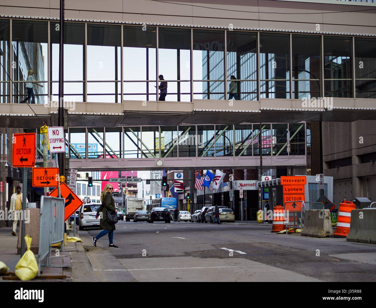 May 3, 2017 - Minneapolis, Minnesota, U.S - Skyways over 7th Street in downtown Minneapolis. The skyways are enclosed pedestrian overpasses that connect downtown buildings. The Minneapolis Skyway was started in the early 1960s as a response to covered shopping malls in the suburbs that were drawing shoppers out of the downtown area. The system grew sporadically until 1974, when the construction of the IDS Center and its center atrium, called the Crystal Court, served as a hub for the downtown skyway system. There are 8 miles of skyways, connecting most of the downtown buildings from Target Fie Stock Photo