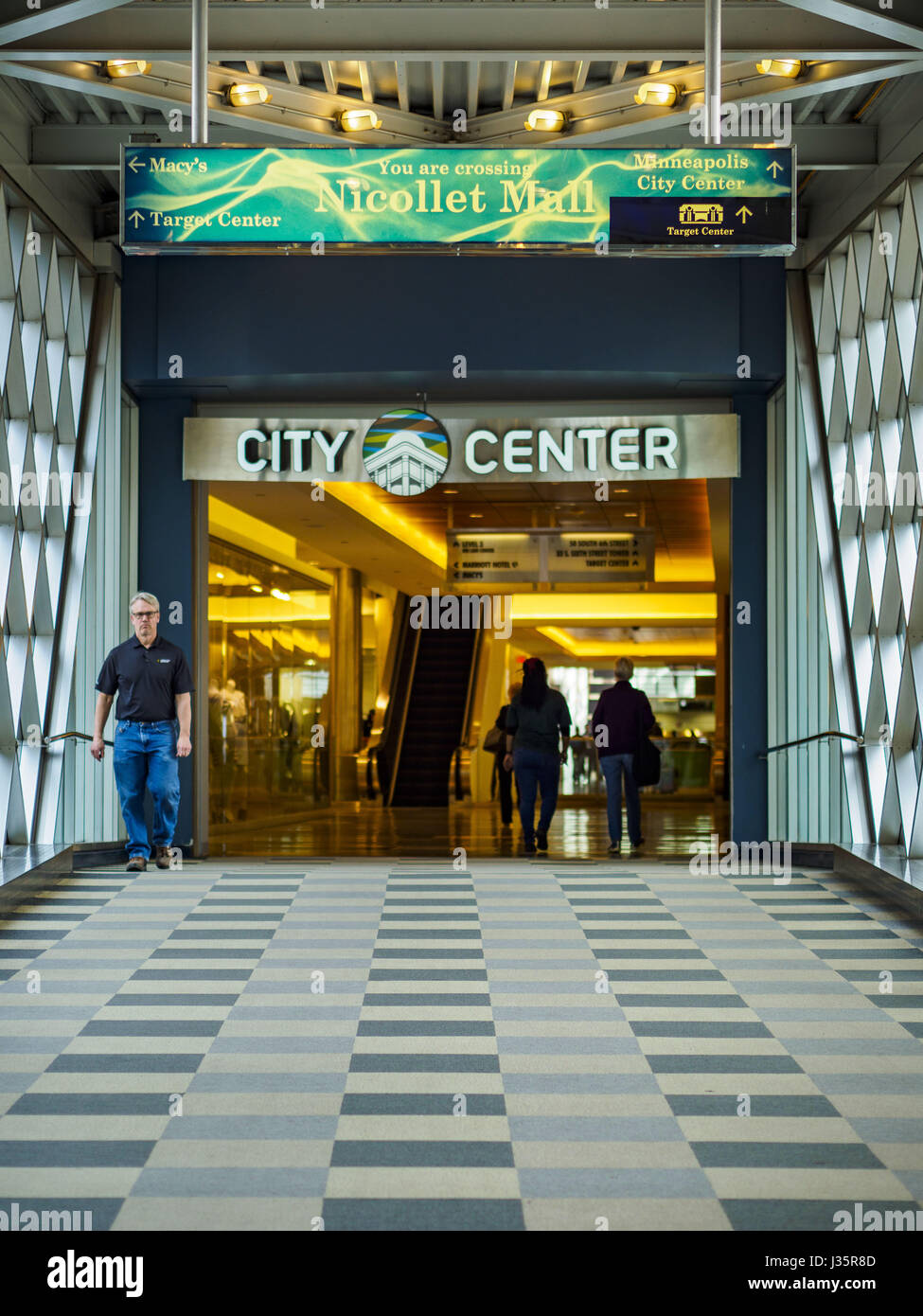 May 3, 2017 - Minneapolis, Minnesota, U.S - The skyway going into City Center in Minneapolis. The skyways are enclosed pedestrian overpasses that connect downtown buildings. The Minneapolis Skyway was started in the early 1960s as a response to covered shopping malls in the suburbs that were drawing shoppers out of the downtown area. The system grew sporadically until 1974, when the construction of the IDS Center and its center atrium, called the Crystal Court, served as a hub for the downtown skyway system. There are 8 miles of skyways, connecting most of the downtown buildings from Target Fi Stock Photo