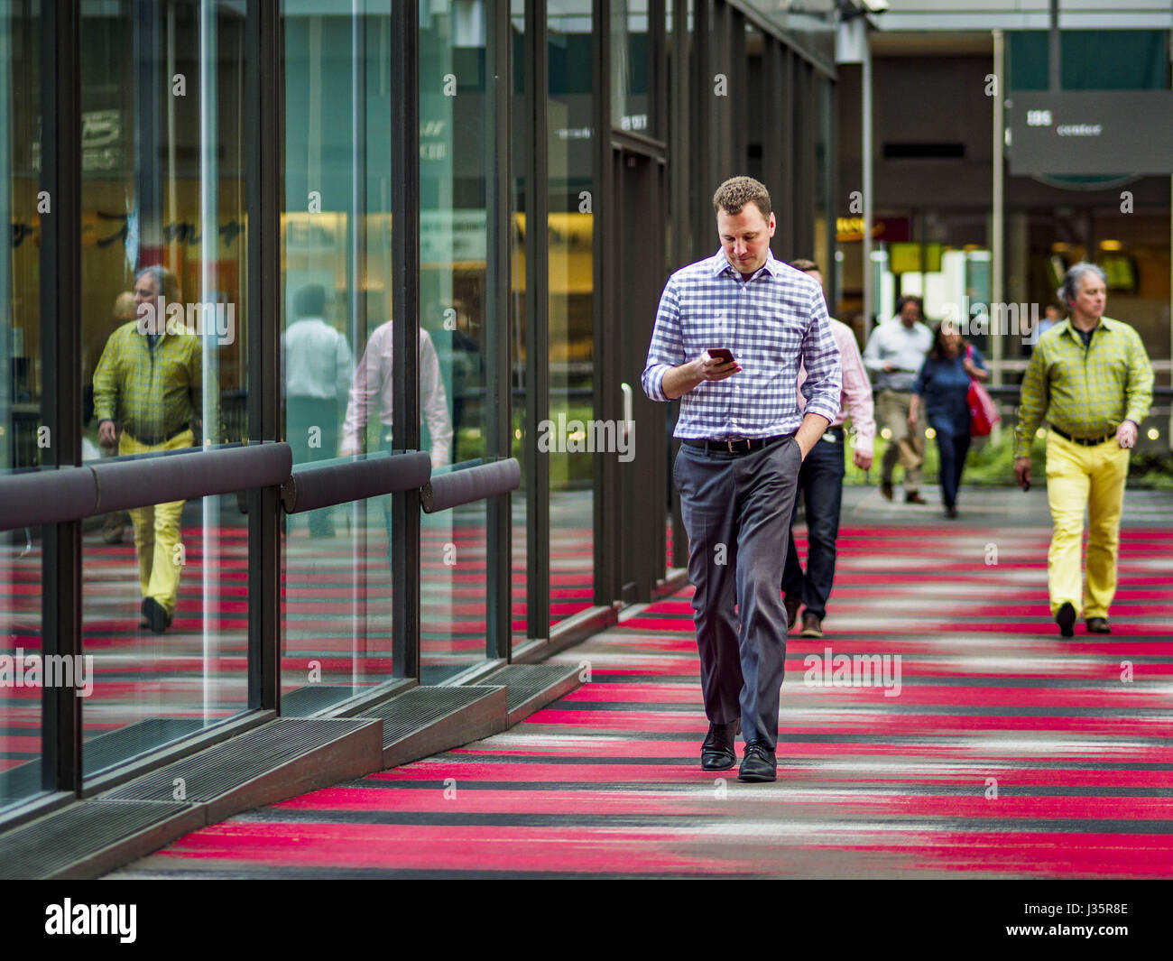 May 3, 2017 - Minneapolis, Minnesota, U.S - People going into the IDS Center, the hub of the Minneapolis skyway system. The skyways are enclosed pedestrian overpasses that connect downtown buildings. The Minneapolis Skyway was started in the early 1960s as a response to covered shopping malls in the suburbs that were drawing shoppers out of the downtown area. The system grew sporadically until 1974, when the construction of the IDS Center and its center atrium, called the Crystal Court, served as a hub for the downtown skyway system. There are 8 miles of skyways, connecting most of the downtow Stock Photo