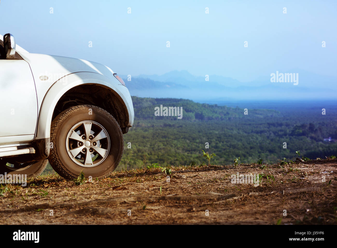 4x4 car on mountains valley backdrop Stock Photo