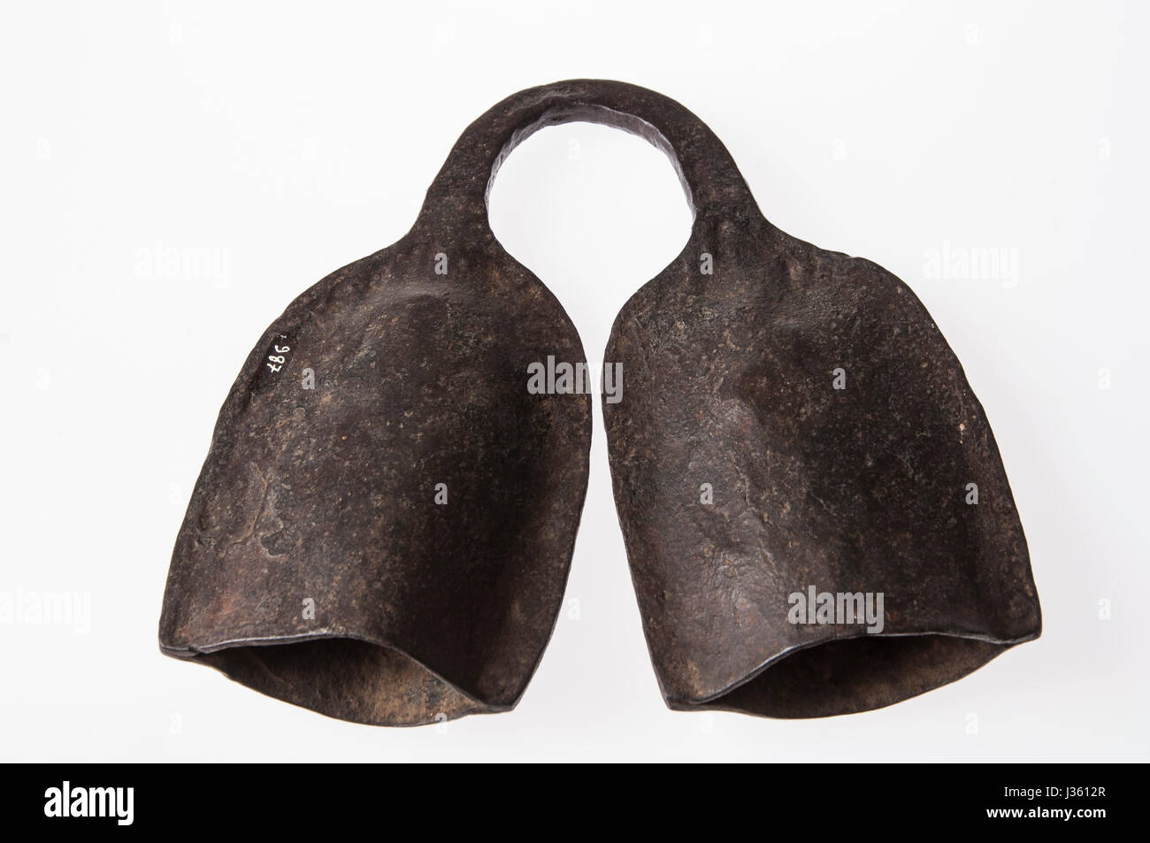 African instrument made by hand, brass, kind of bell, isolated on white