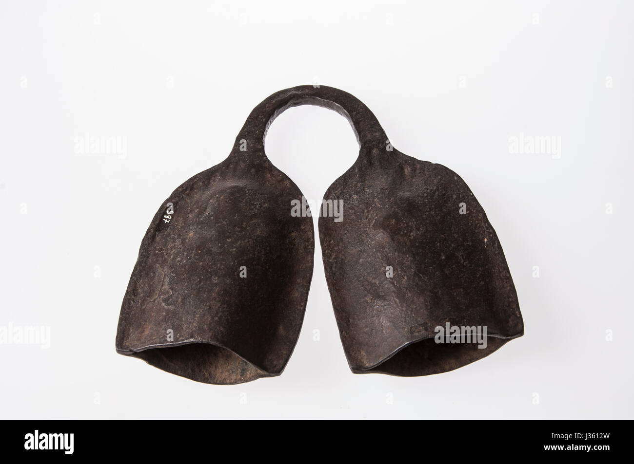 African instrument made by hand, brass, kind of bell, isolated on white