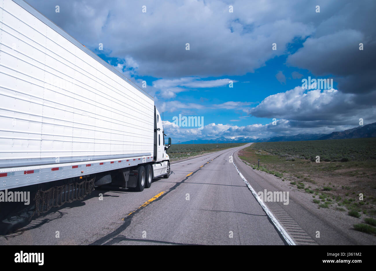 Semi Truck with refrigerated trailer and chains hanging under the
