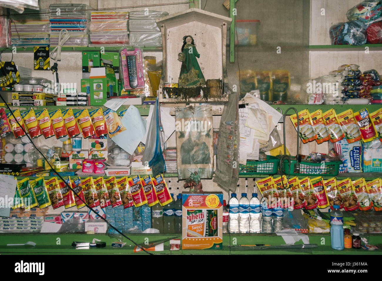 Polillo Island, Philippines - April 30, 2017: Goods for sale and religious images displayed at a local sari-sari store on the Polillo Island in the Ph Stock Photo