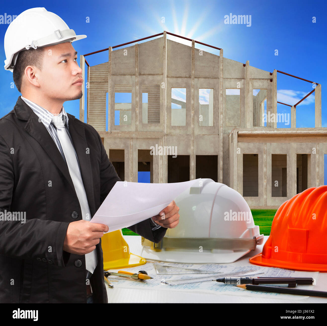 architect man and working ducument plan in house construction site with working table scen foreground Stock Photo