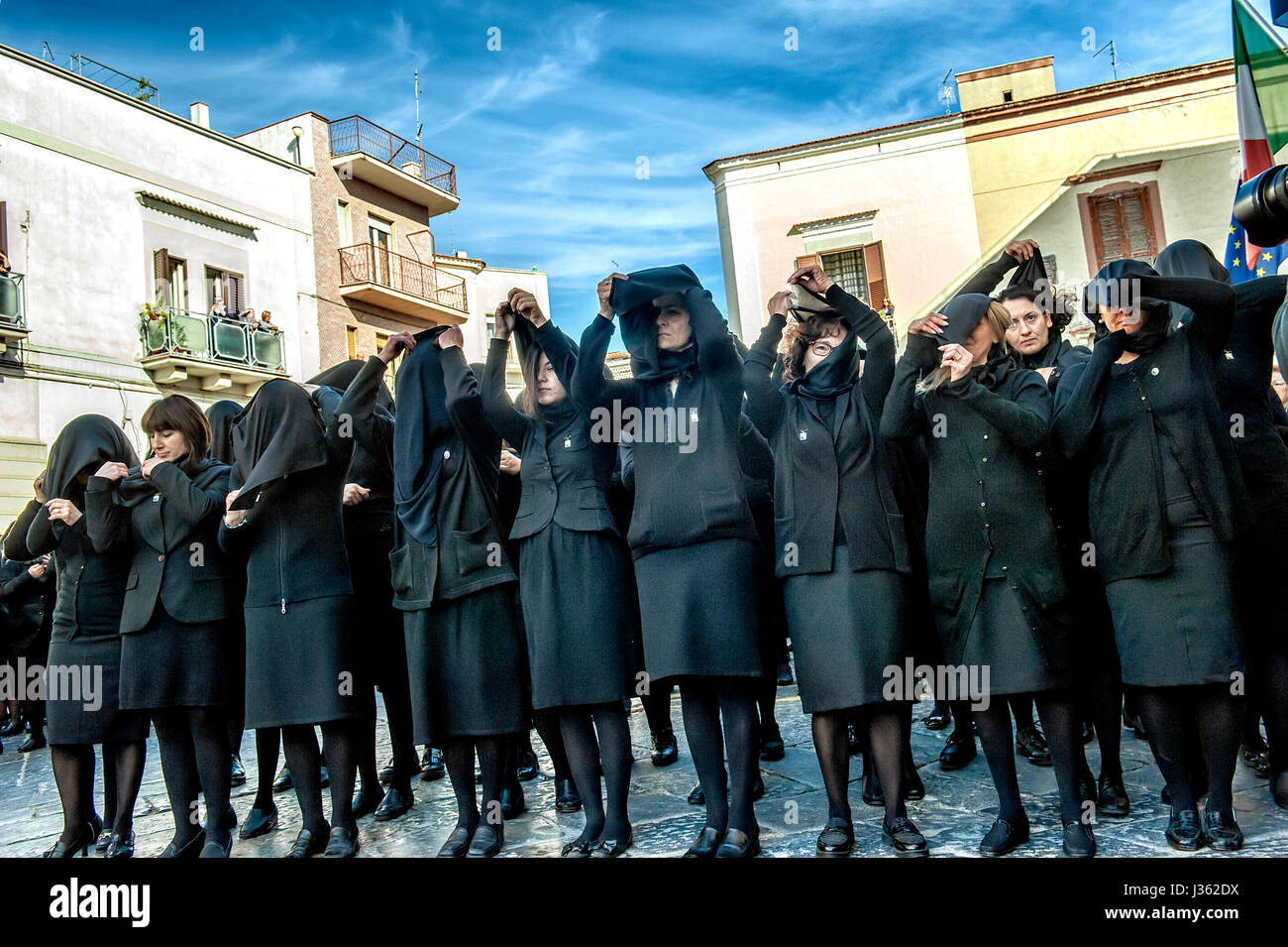 The women in black who will follow the Madonna Desolata in procession raise the black veil that will cover the entire their face Stock Photo
