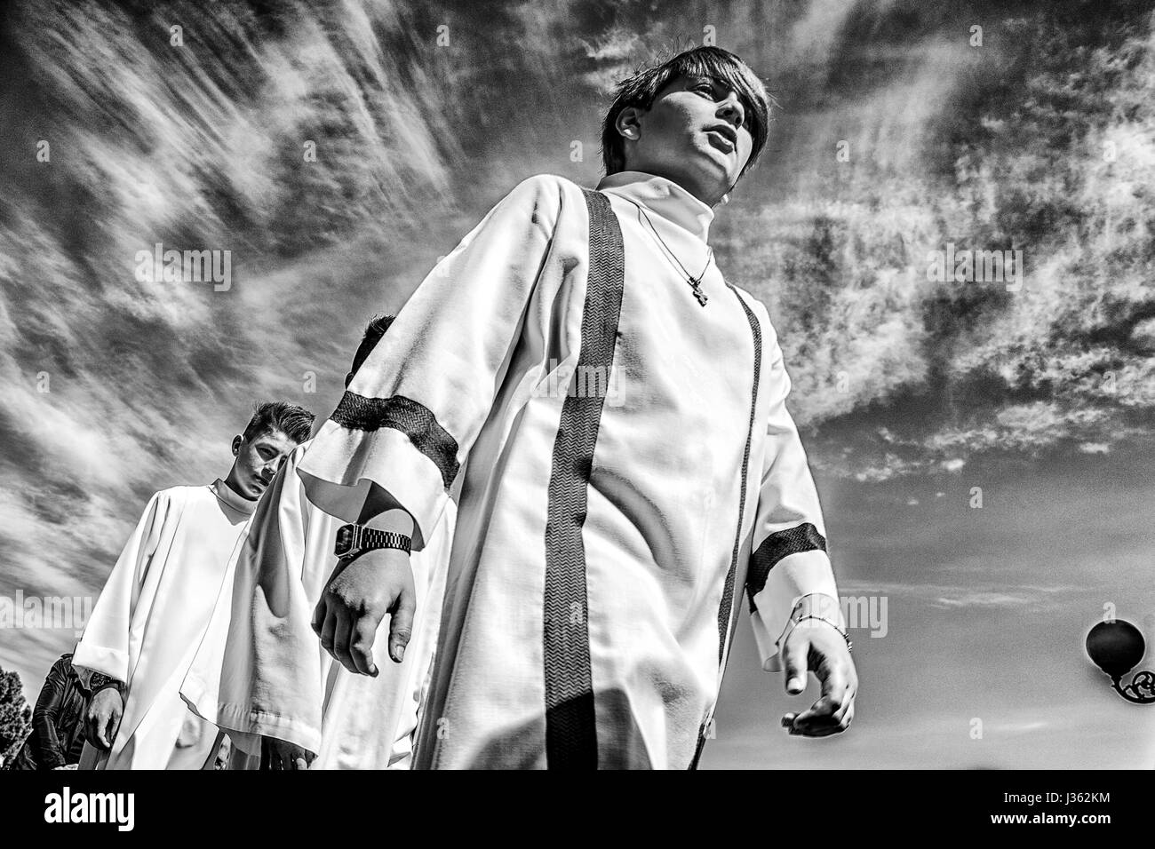 Boys in white tunics parading during the procession of the Madonna Desolata, in Canosa di Puglia village, Italy Stock Photo