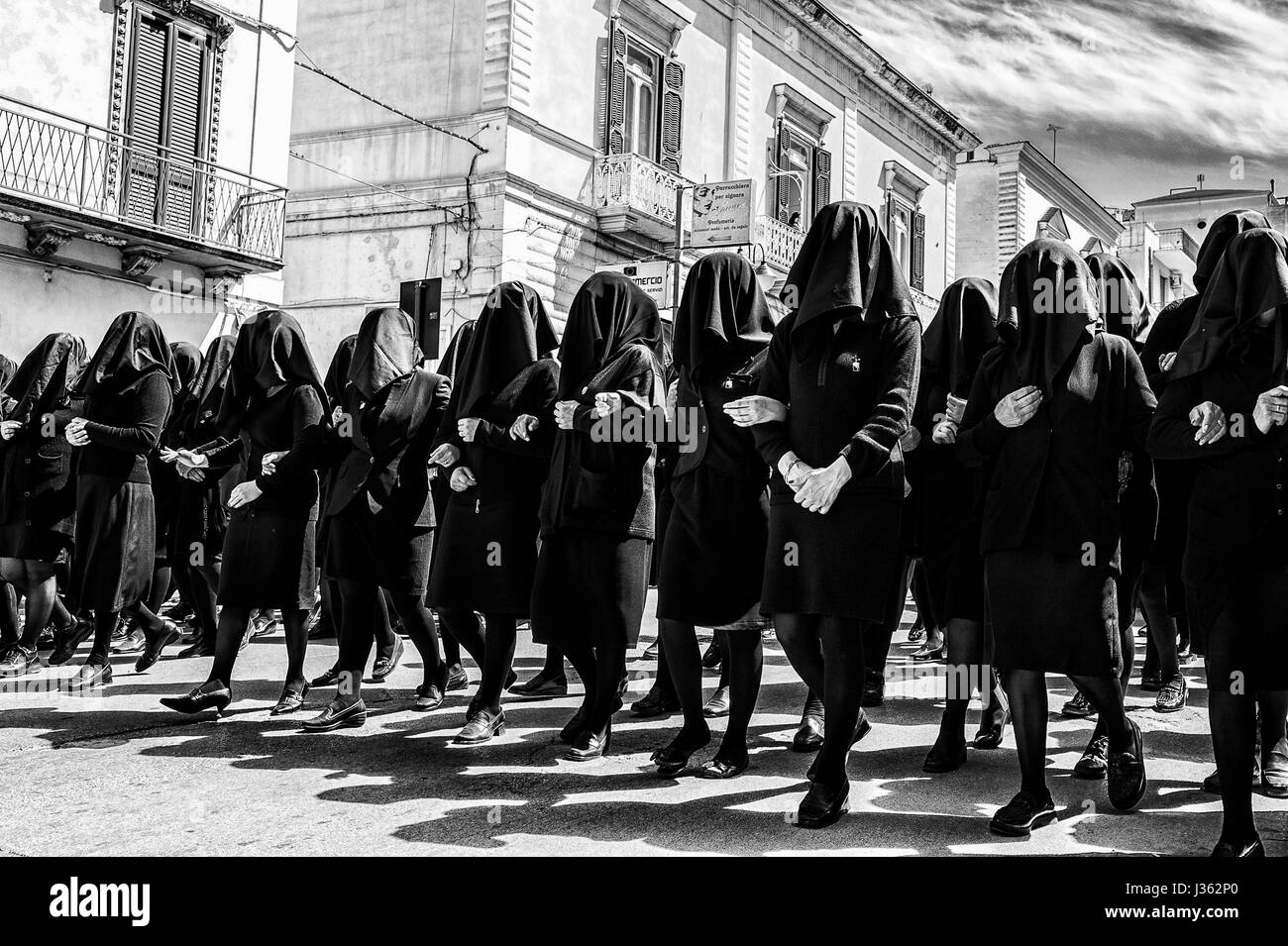 The women dressed in black parading along the streets of Canosa di Puglia village, Italy, during the procession of the Madonna Desolata Stock Photo